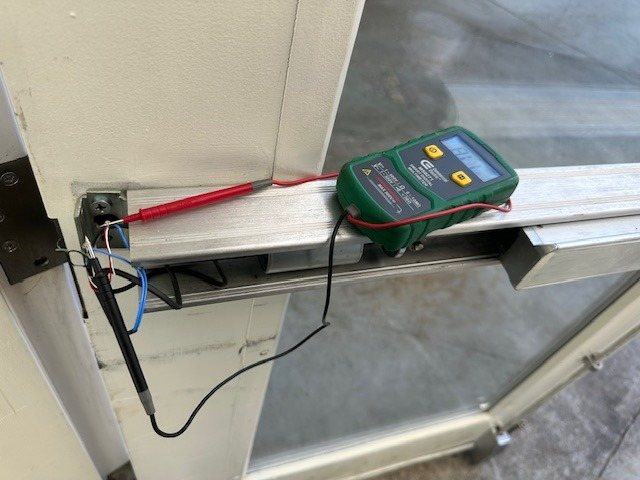 Technician testing low voltage wiring